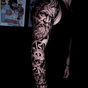 Tatto on the right arm of the man showing some face of the old man